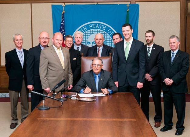 Gov. Jay Inslee signs a bill on Monday that clarifies players in the Western Hockey League as amateur athletes.