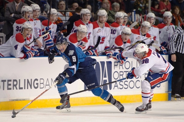 The Thunderbirds' Justin Hickman darts up the ice with the puck with the Chiefs' Jackson Playfair in pursuit.