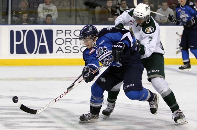 The Thunderbirds’ Sam McKechnie fires the puck with the Silvertips’ Jujhar Khaira on his back during WHL action Saturday night at the ShoWare Center.