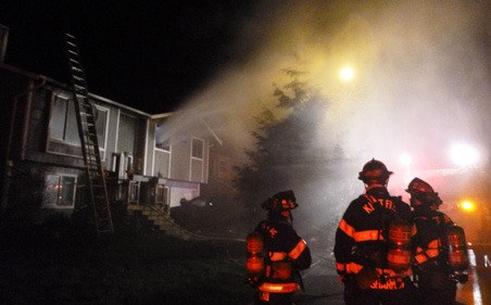 Firefighters attack a house fire Saturday morning in the 22900 block of 114th Way Southeast on the East Hill in Kent.