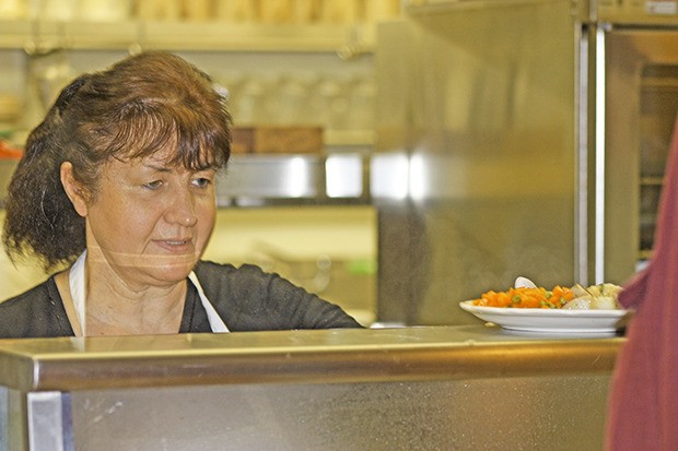 Nellie Dondarets serves up lunch during the Kent Parks Deli & Cafe's 20th anniversary celebration at the Kent Senior Activity Center earlier this year. A summer concert fundraiser is set to support the lunch program.