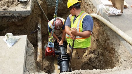 Crews work on a water main in Kent.