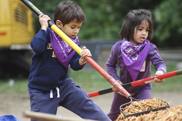 Zoheb (left) and Zohra McBride rake a giant pile of leaves