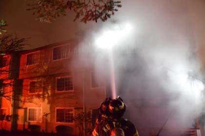 Firefighters douse a two-alarm apartment fire in Kent early Sunday morning. The fire displaced several families.