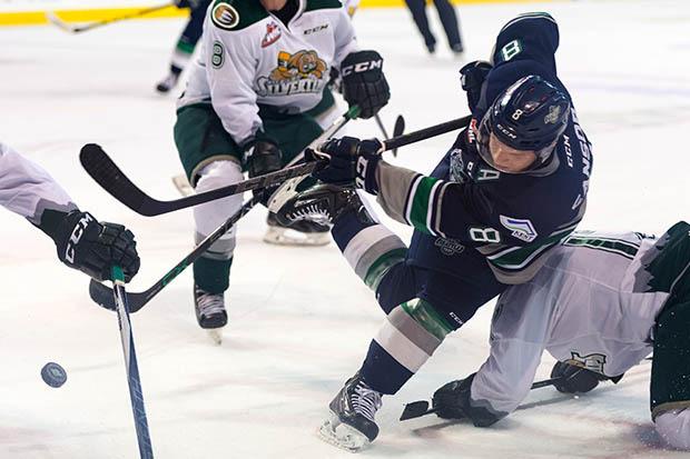 The Thunderbirds' Scott Eansor battles for the puck against the Silvertips during Saturday night's game at the ShoWare Center.