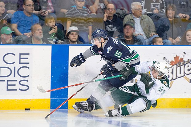 The Thunderbirds' Lane Pederson and the Silvertips' Ivan Nikolishin battle for the puck during WHL play Saturday night at the ShoWare Center.