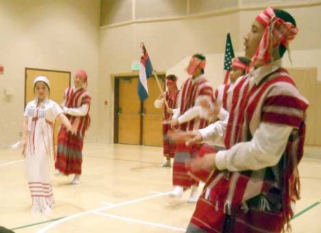 Karen teens lead a New Year’s celebration with song and dance Jan. 1 at Kent Covenant Church. The celebration was a traditional Burmese event