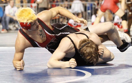 Kentlake's Jesse Keliiliki works over Inglemoor's Ben Grabowski 10-0 during a consolation match. Keliiliki went on to take fourth place at Mat Classic XXIII.