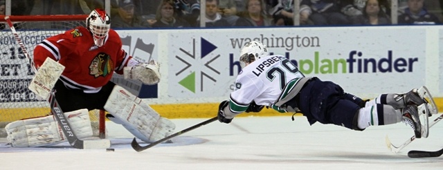 The Thunderbirds' Roberts Lipsbergs stretches to deliver a shot at Blackhawks goalie Brendan Burke during WHL action Friday night.