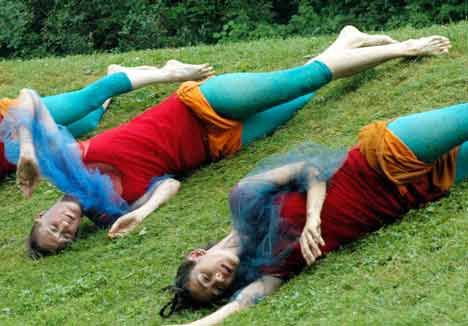 Dancers connected with the wet earth at Herbert Bayer Earthworks Park in Kent