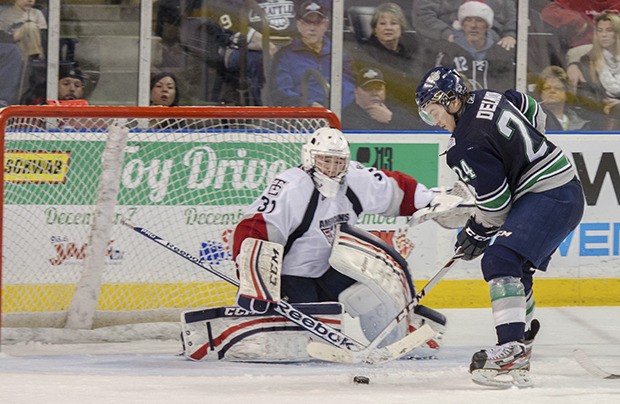 The Thunderbirds' Alexander Delnov tries to push the puck past Americans goalie Evan Sarthou. Delnov had four points in Seattle's win.