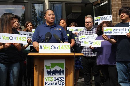 I-1433 sponsor Ariana Davis addresses the media after initiative signatures were delivered to the Elections Division Wednesday morning to raise the state minimum wage.