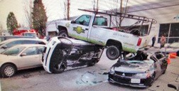 A pickup landed on two cars after crashing Friday