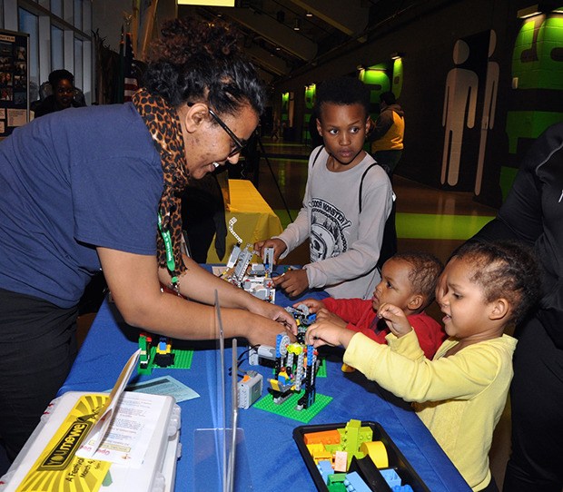 Selam Gebretsadik from Bricks 4 Kidz works with kids on a project during the You Me We festival at the ShoWare Center.