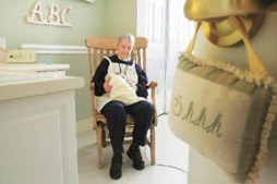 Sister Janet Benish comforts a baby in 2008 as a volunteer at the Pediatric Interim Care Center in Kent.