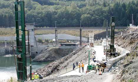 The Army Corps of Engineers had three drills pumping grout and drilling holes 24 hours to finish a grout curtain on the right abutment of the Howard Hanson Dam last September. In the background of the right abutment is the control tower for the dam and the spill way. The grout curtain was an interim repair. Federal funds have now been secured to put the dam in line for a permanent fix.