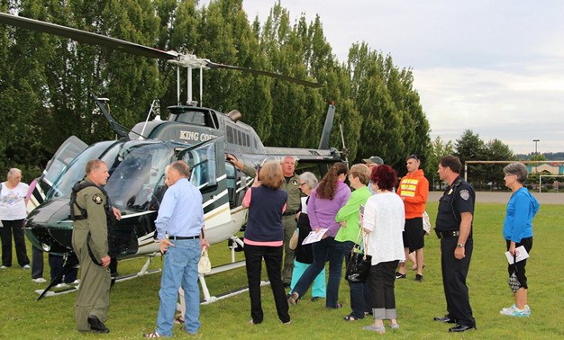 Residents who attended a Kent Police Community Meeting on June 22 got to check out King County's Guardian One helicopter. Kent Police Chief Ken Thomas stands second from the right.