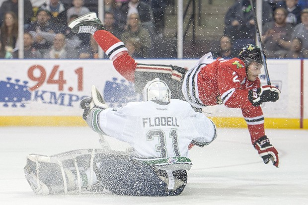 T-Birds goalie Logan Flodell defends as the Winterhawks' Anton Cederholm is upending during WHL play Saturday night.