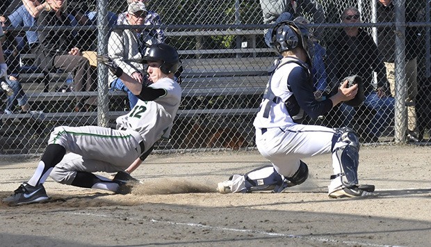 Kentwood's Kade Kryzsko slides safely home against Auburn Riverside during SPSL 4A play earlier this season. Kryzsko and the Conks are back in the state playoffs.