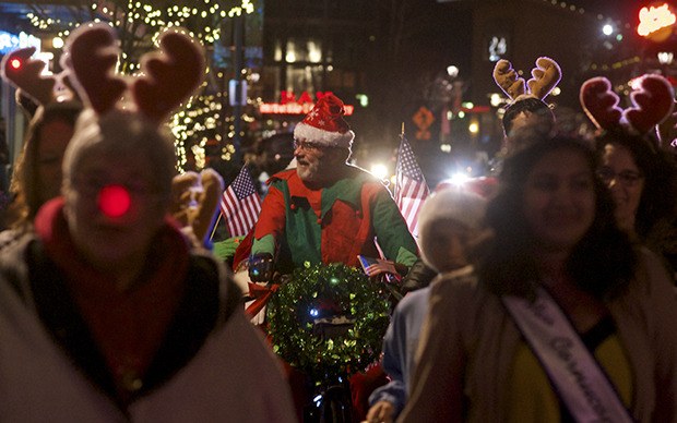 Don Dinsmore guides Santa on his pedicab sleigh along Ramsay Way during Kent Winterfest last Saturday. Mayor Suzette Cooke