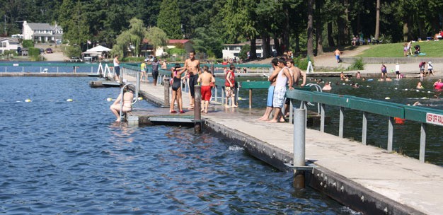 Swimmers enjoy the Lake Meridian Park swim and fishing dock.