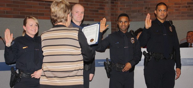 Kent Mayor Suzette Cooke swears in new police officers Brittany Rios; Andrew Richardson; Kamal Sharif and Junior Coffin on Jan. 21 at the City Council meeting.