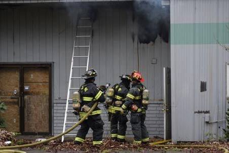 Kent firefighters combat a blaze on March 25 at an empty building on Lincoln Avenue used by the homeless.