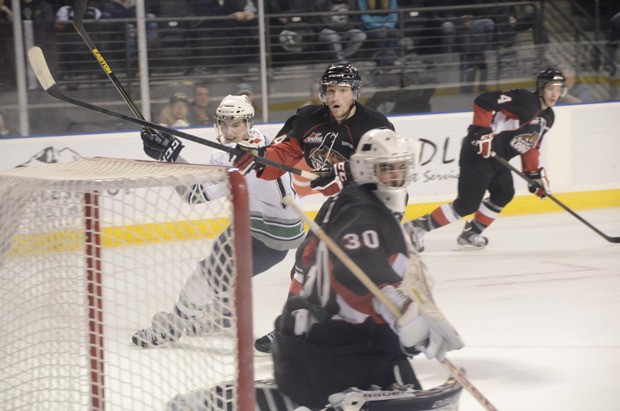 The T-Birds' Shea Theodore fires a shot at Cougars goalie Mac Engel. Theodore had two goals in the win.