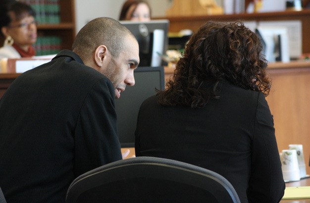 William Phillip Jr. talks Friday in Kent with one of his defense attorneys after a King County Superior Court jury convicted him of first-degree murder for the 2010 stabbing death of Seth Frankel.