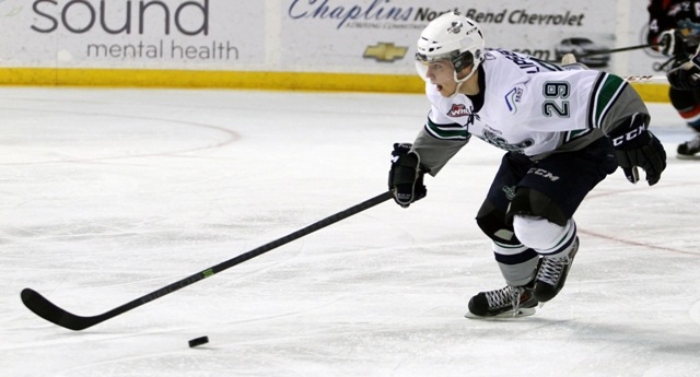 Thunderbirds wing Roberts Lipsbergs pushes the puck against Kelowna