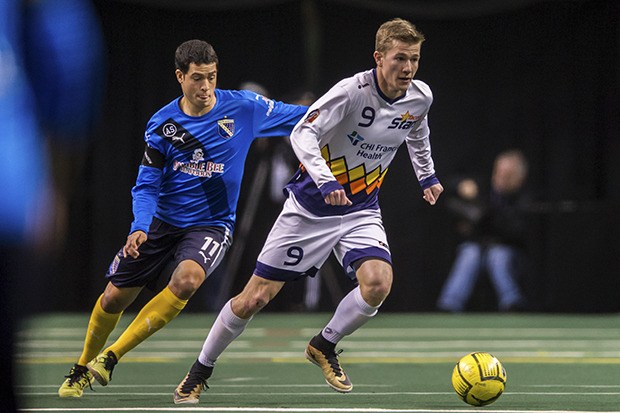 Stars striker Derek Johnson pushes the ball up the field.