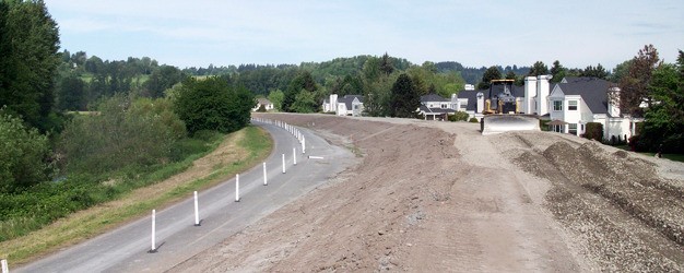 Crews bulldoze last week as part of the repair work on the State Route 516 to South 231st Way levee along the Green River.