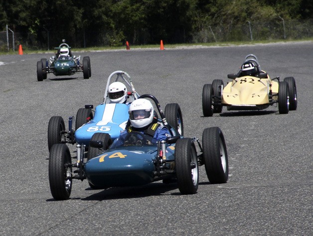 A pack of vintage racers roars around the track on the Pacific Raceways road course. Sports car racers come to Kent this weekend for the J. Tom Masterson Memorial 32nd annual Double “Rational.”