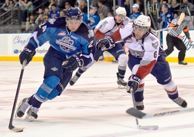 The T-Birds’ Alexander Delnov pushes the puck up the ice against the Americans’ Justin Harmonic.