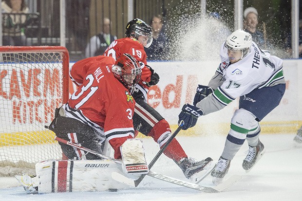 The T-Birds' Shea Theodore scores against Winterhawks goalie Adin Hill in the second period Tuesday night.