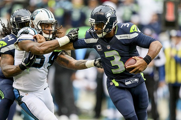 Seahawks quarterback Russell Wilson tries to avoid Panthers linebacker Shaq Thompson during their Oct. 18 game at CenturyLink Field. The play ended with a penalty on Seahawks running back Marshawn Lynch for holding. The Seahawks lost 27-24. The teams collide again Sunday in the NFC playoffs.