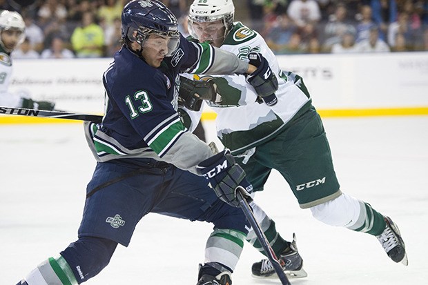 The Thunderbirds' Mathew Barzal battles the Silvertips' Cole MacDonald during WHL action Saturday night.