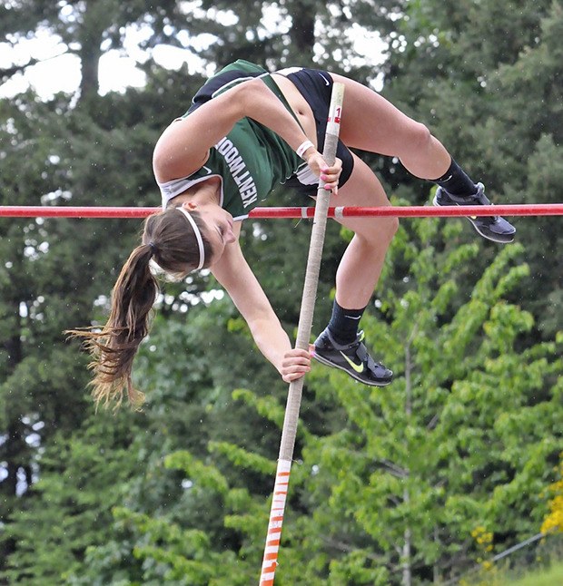 Kentwood’s Beth Parrish soars to first place in the pole vault at the 4A West Central District meet.