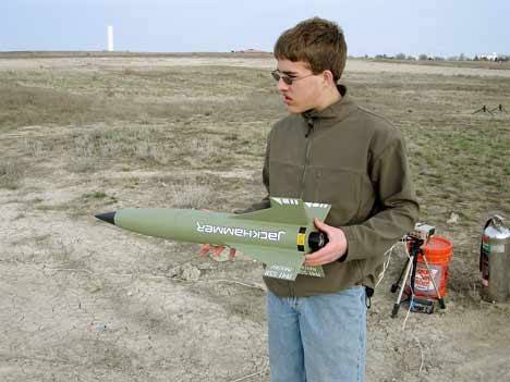 Kentwood Astronomical Society member Lee Tillotson holds a rocket ready for launch.