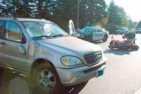 A fatal accident involving a Mercedes sport utility vehicle (front) and a motorcycle (background) saw response from multiple emergency providers Tuesday