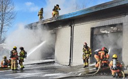 Firefighters work to extinguish a commercial building fire on Friday in SeaTac.