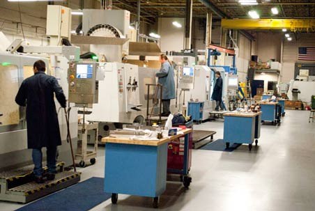 Crews work at the machine shop at Blue Origin in Kent.