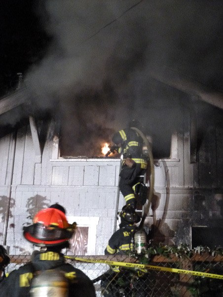 Kent firefighters battle a blaze Wednesday night at an abandoned home in the 400 block of Alder Lane.