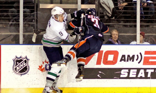 Seattle Thunderbird Justin Hickman hits Kamloops Blazer Marek Hrbas off his skates Jan. 20 at the ShoWare Center.