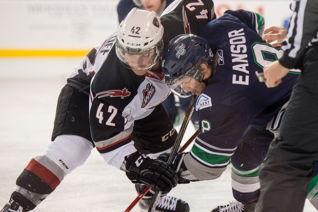 The Thunderbirds' Scott Eansor battles the Giants' Jackson Houck during WHL action at the ShoWare Center on Saturday night.