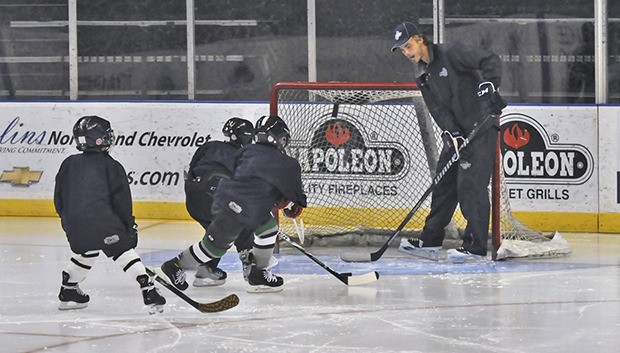 Seattle Thunderbirds goaltender Taran Kozun teaches a group of youngsters in front of the net at the Thunderbirds Hockey School at the ShoWare Center last week.