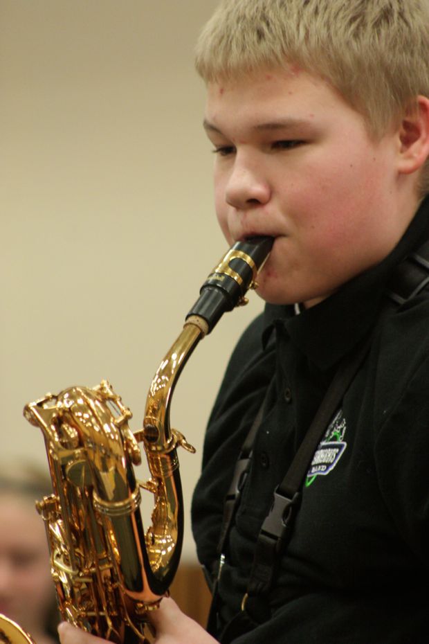 Mathew Thiel plays a selection on his bari saxophone with the Covington's Cedar Heights Middle School Jazz Band on Kids' Arts Day at the Kent Commons on Saturday.