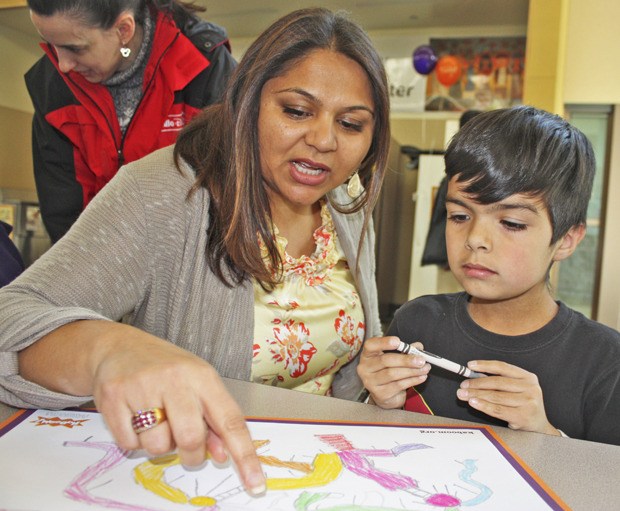 Great work: East Hill Elementary School Principal Daxa Thomas follows the playground design from Juan Najera