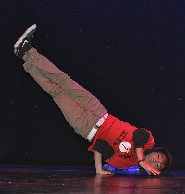 A Kentridge High School student break dances last Friday during a charity show