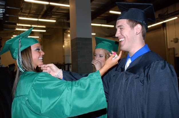 Kaylynn Lawrence and Mitch Hoffman of Kentwood High tease each other before their graduation ceremony last year at the ShoWare Center in Kent.